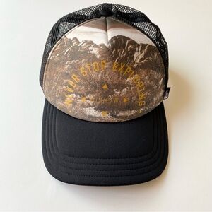 The North Face “Never Stop Exploring” Black and Brown Graphic Trucker Hat